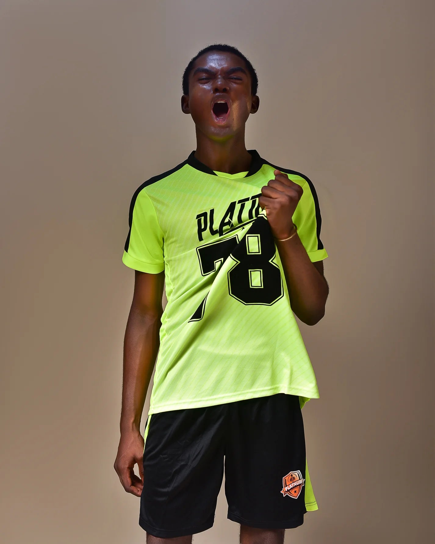 Neon Yellow Platnum Apparel sports Jersey with black shorts 