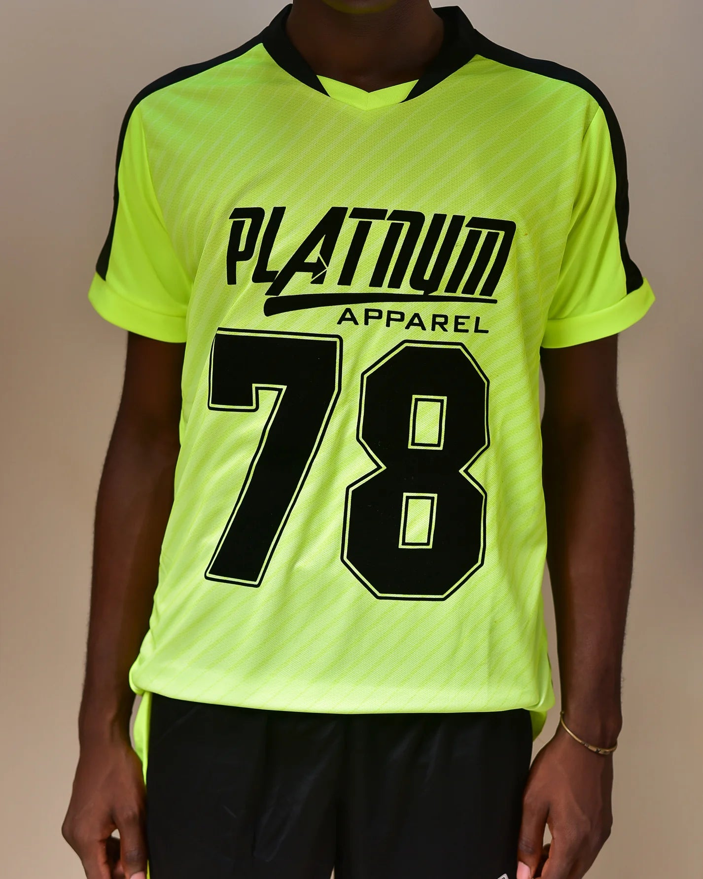 Neon Yellow Platnum Apparel Sports Jersey for Men. Front view. With Black shorts